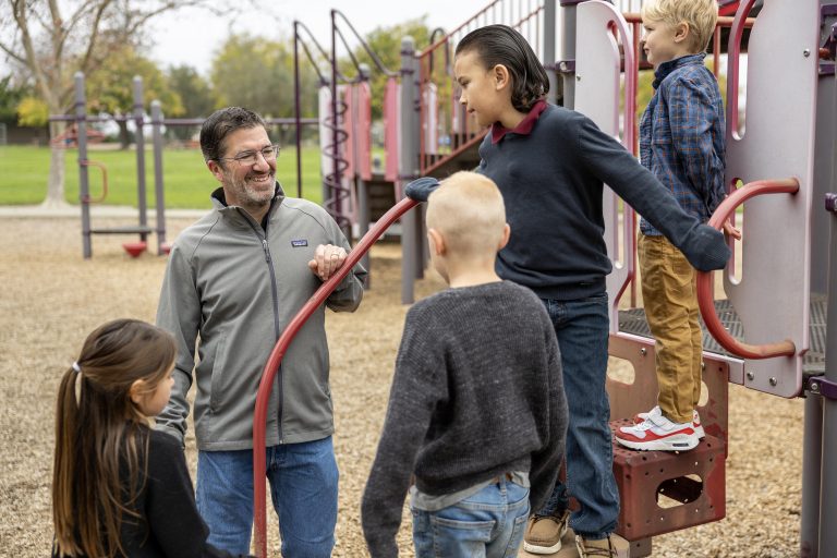 Josh Schultz with kids at Park